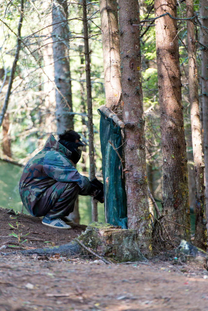 paintball players hide tree